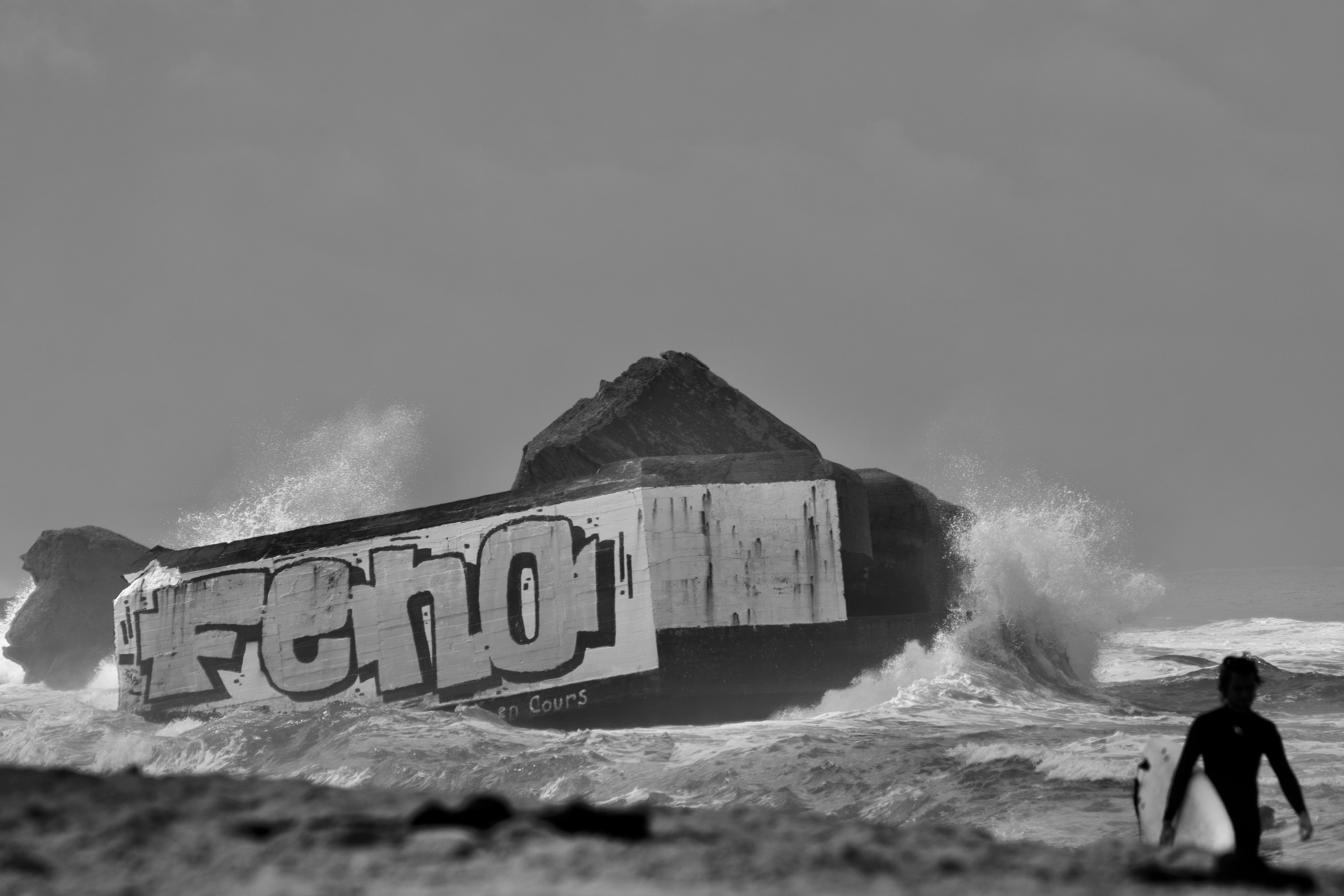 A man standing on top of a surfboard in the ocean