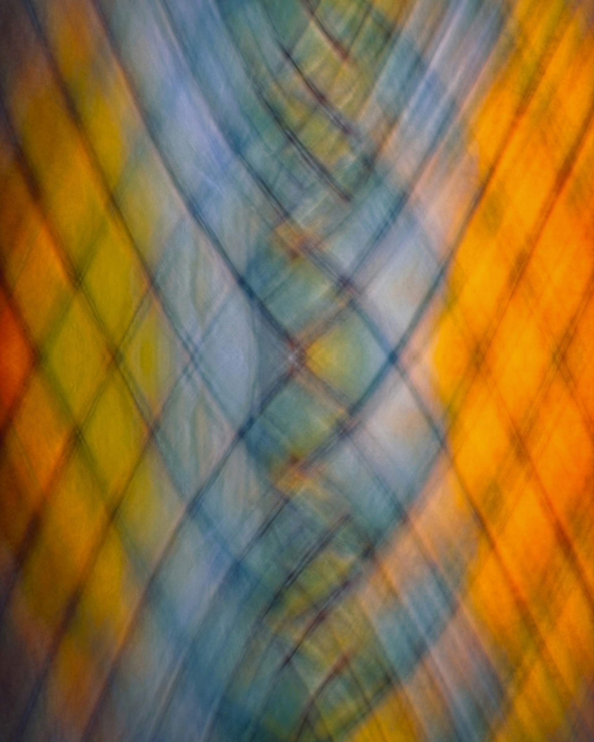 A blurry image of a blue, yellow, and orange background
