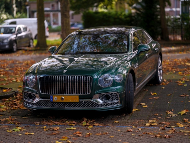 A green car parked on the side of the road