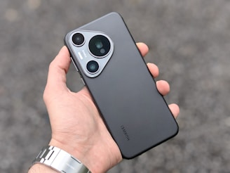 A person holding a cell phone in their hand