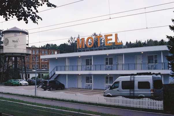 A motel with cars parked in front of it