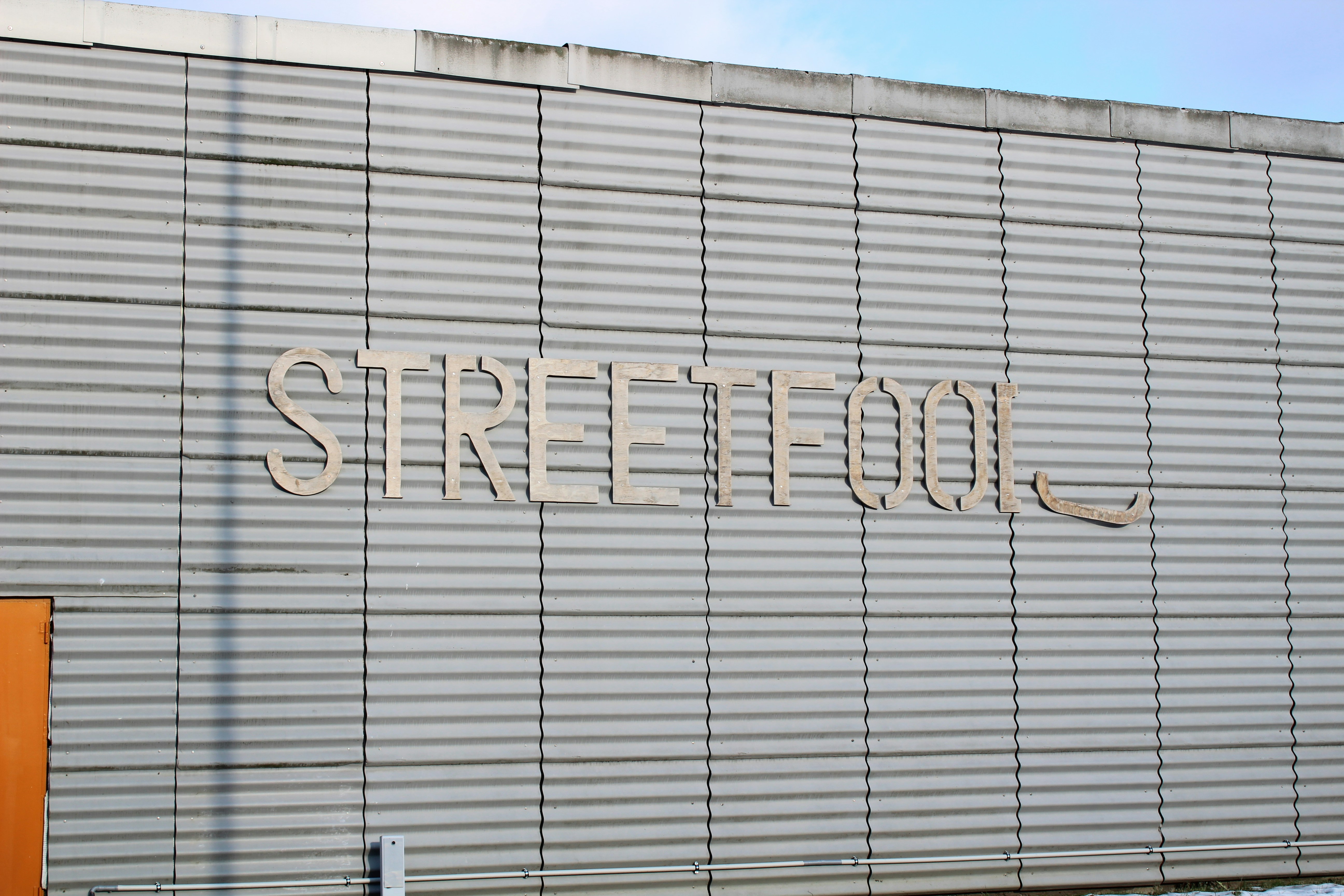 A large building with a street sign on the side of it