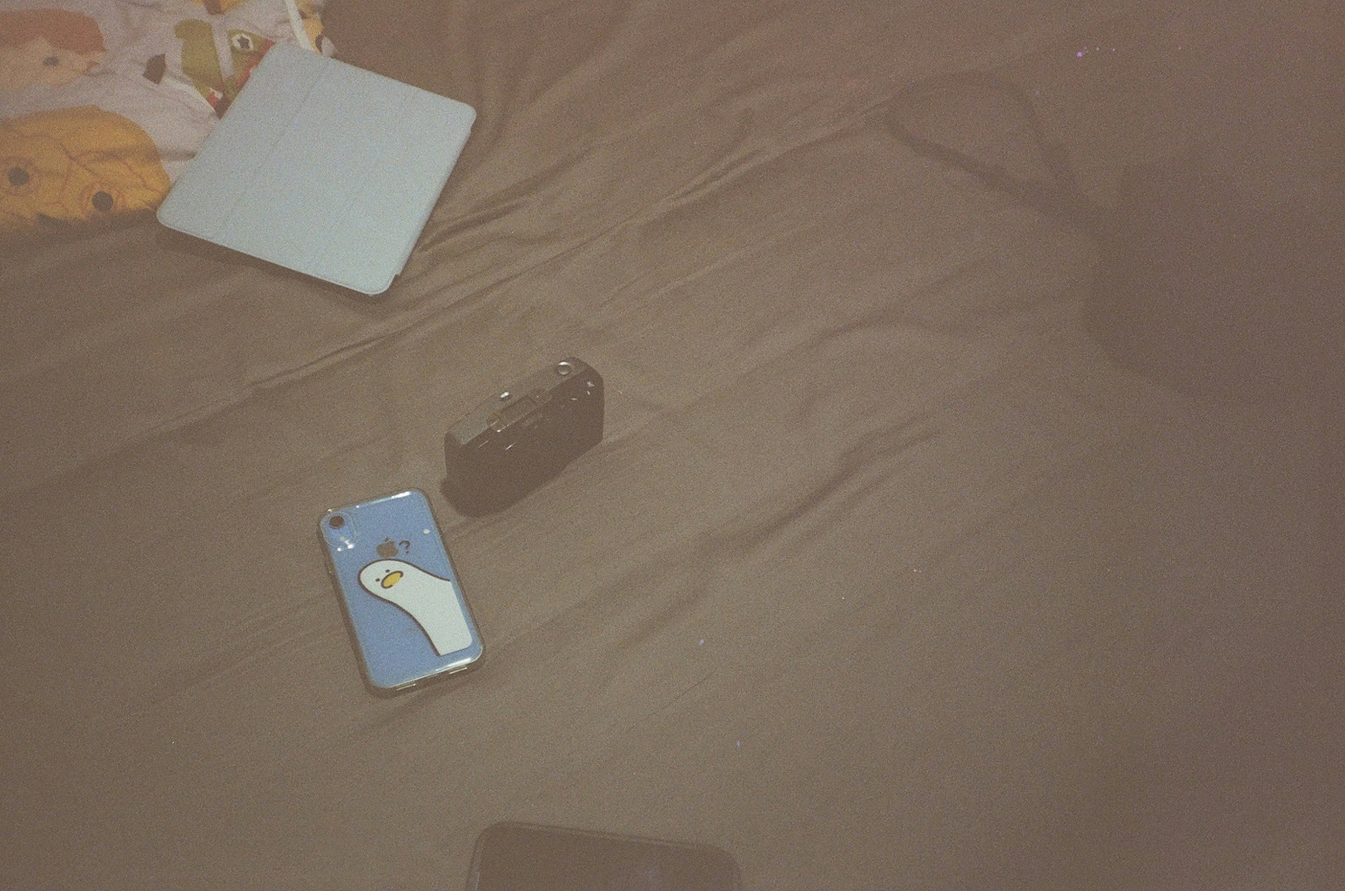A laptop computer sitting on top of a bed