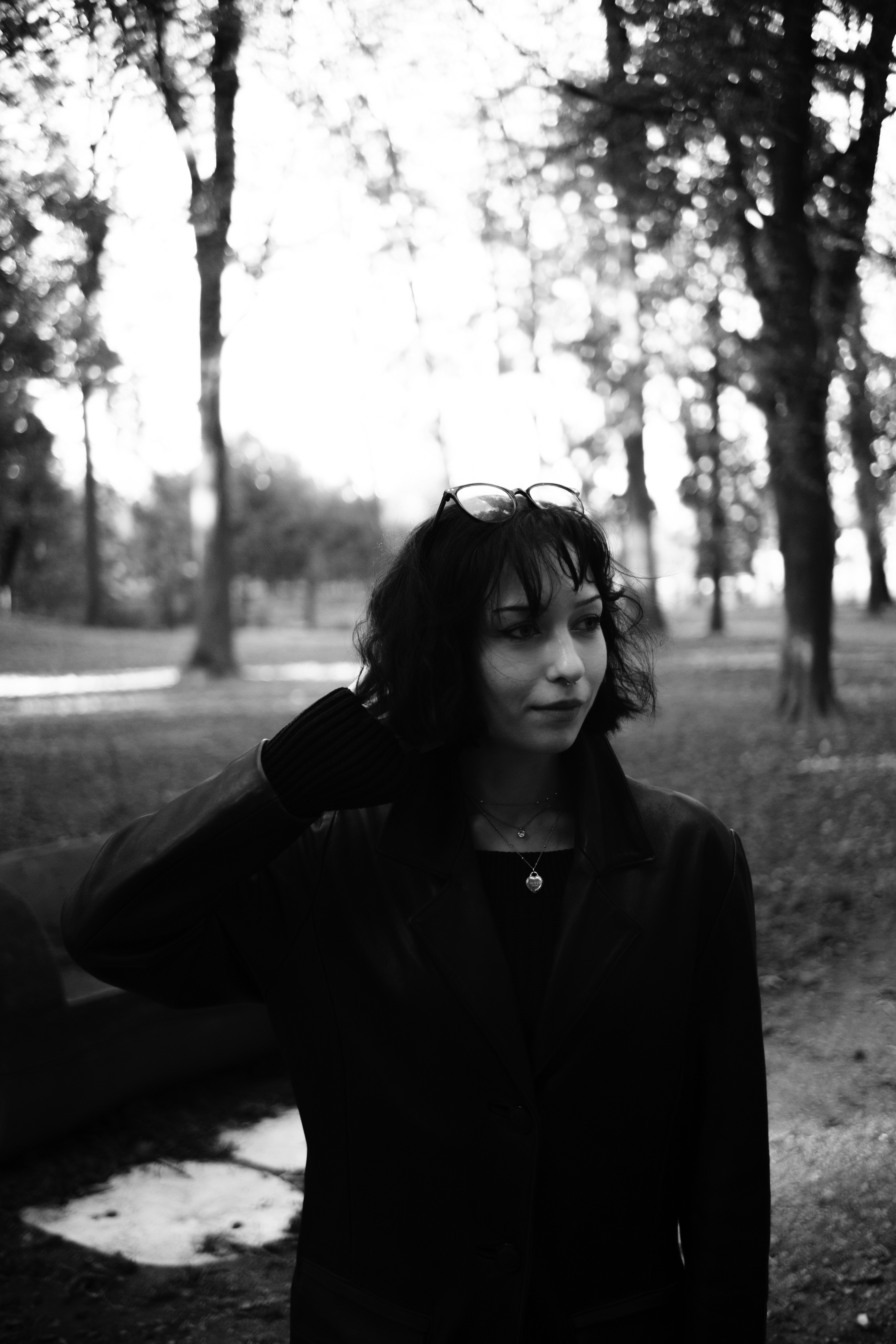 A woman standing in the middle of a park