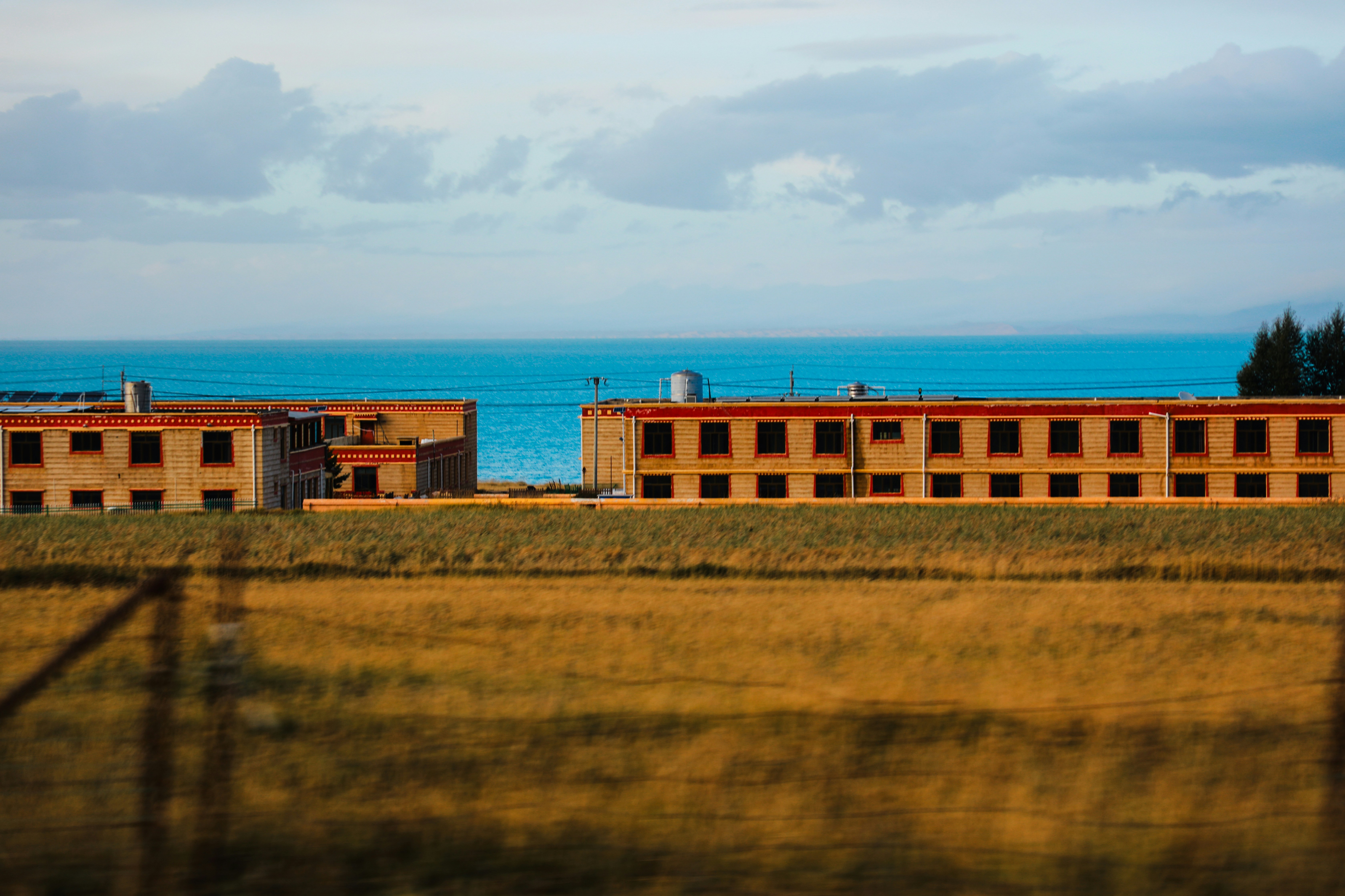 A large building sitting on top of a lush green field