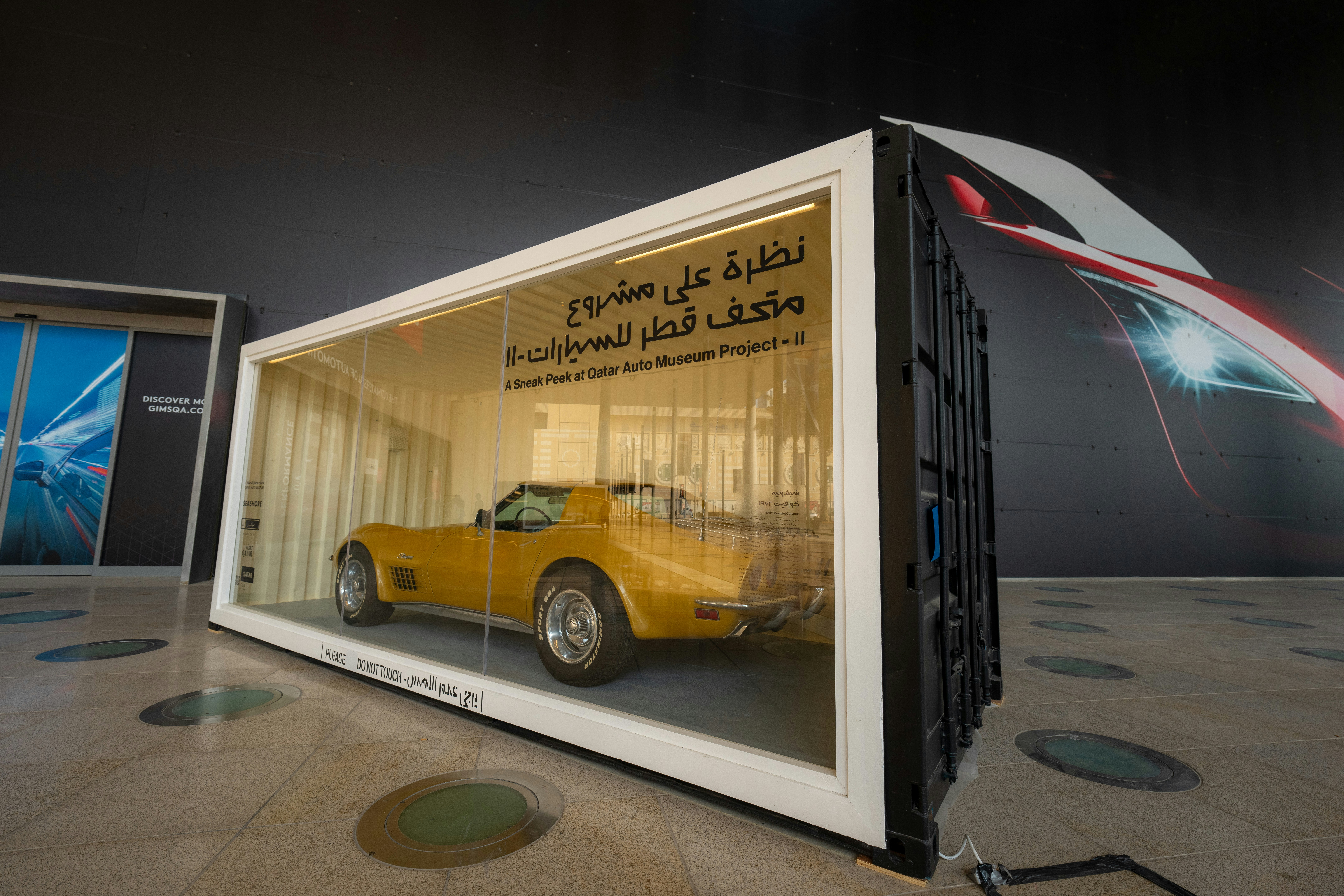 Luxury cars being loaded onto a specialized car carrier