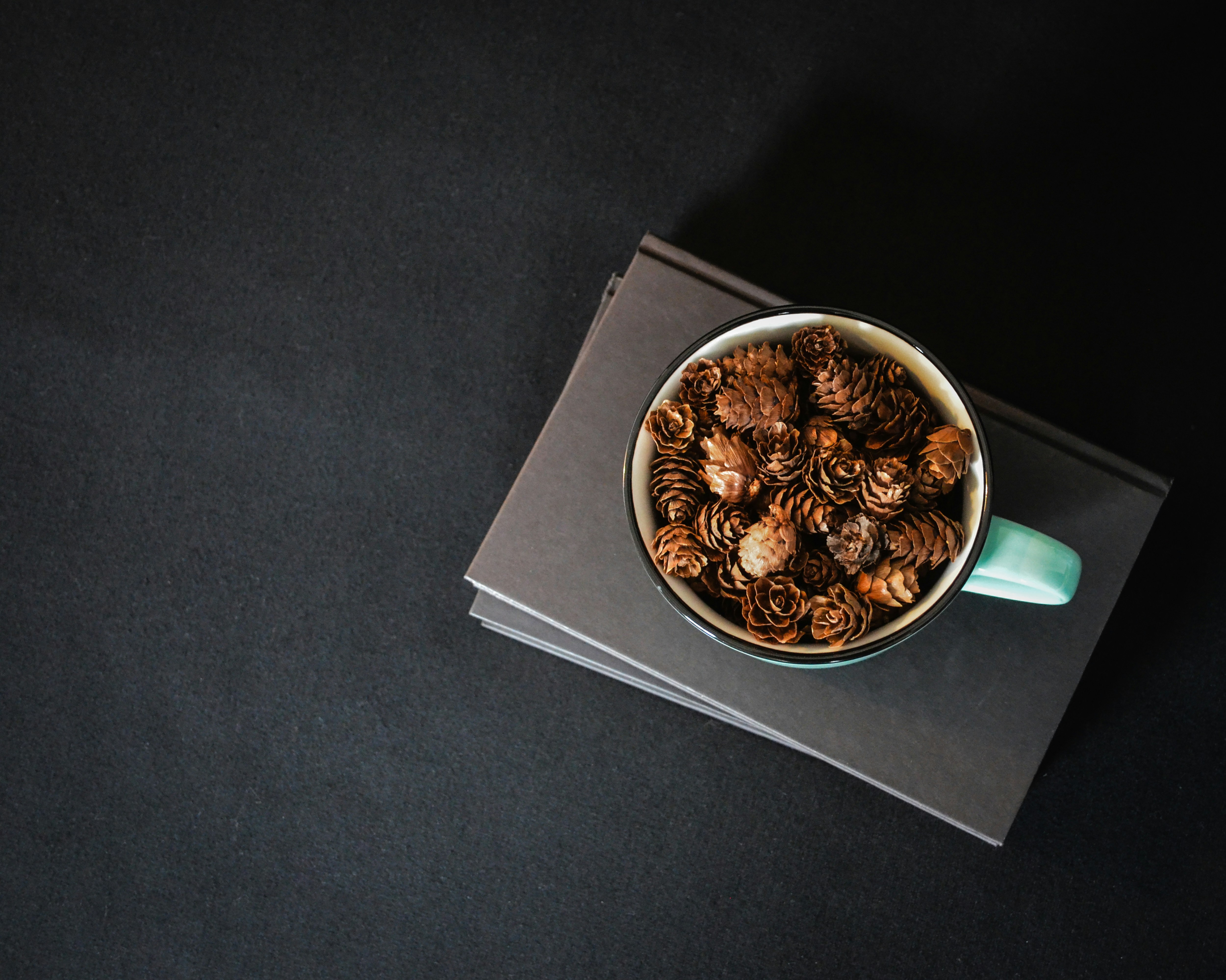 A bowl filled with nuts on top of a black table
