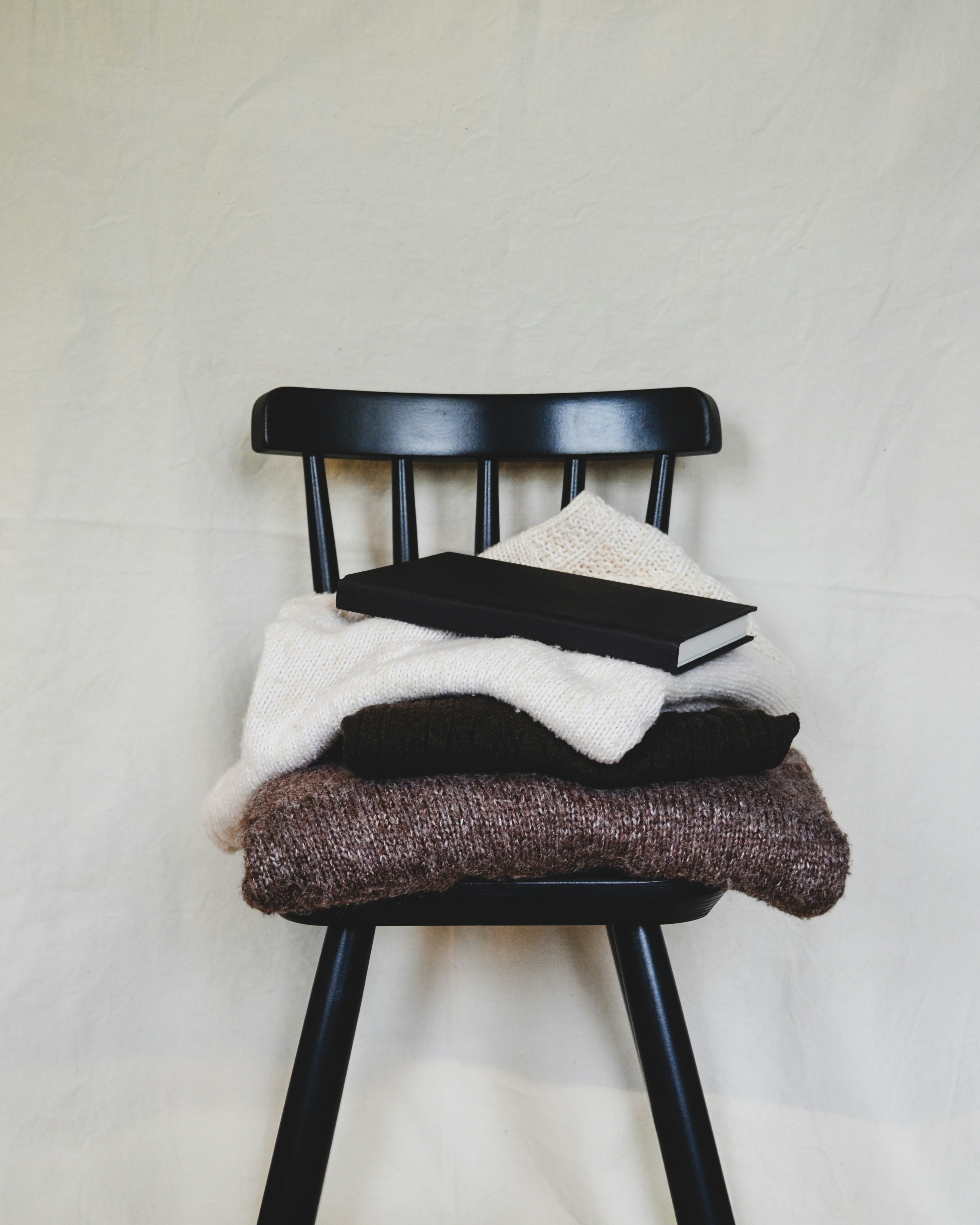 A chair with a pile of blankets on top of it