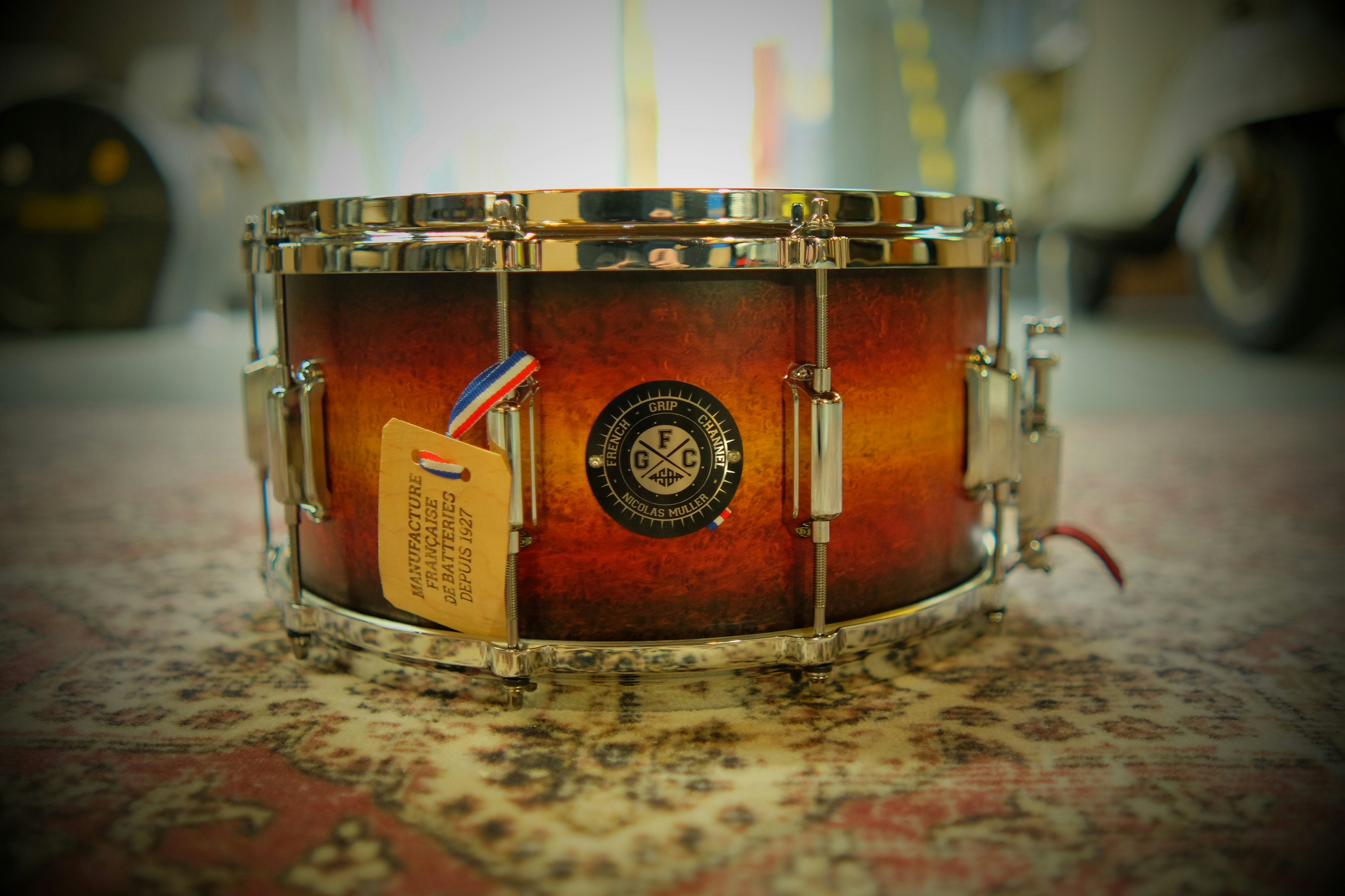 A close up of a drum on a carpet