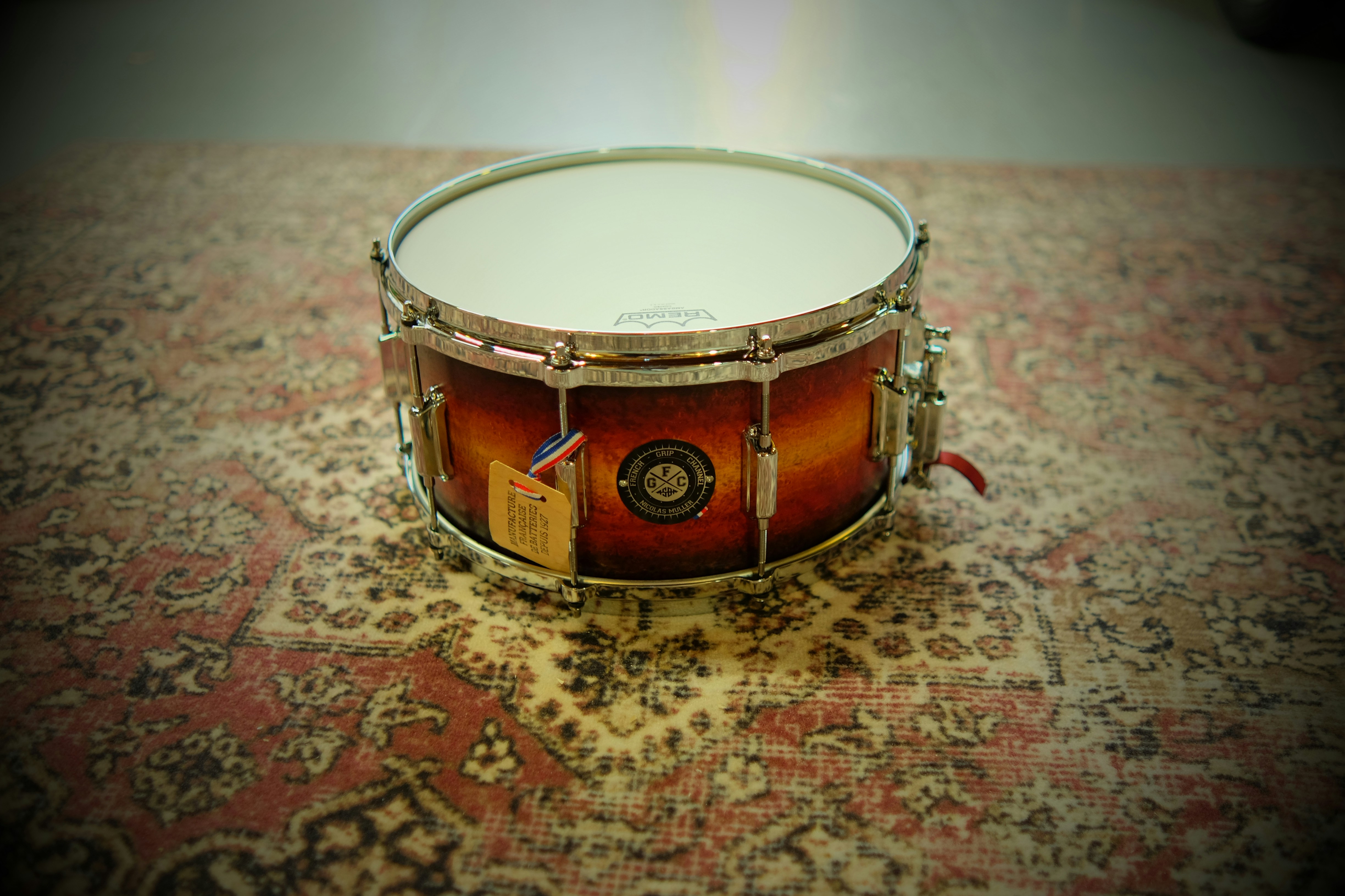 A close up of a drum on a rug