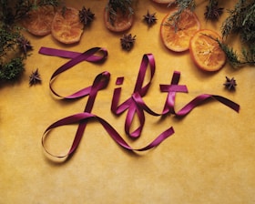 A picture of some fruit and ribbon on a table