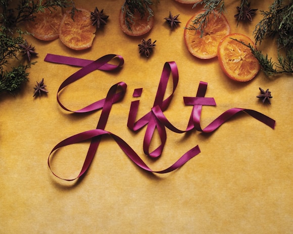 A picture of some fruit and ribbon on a table