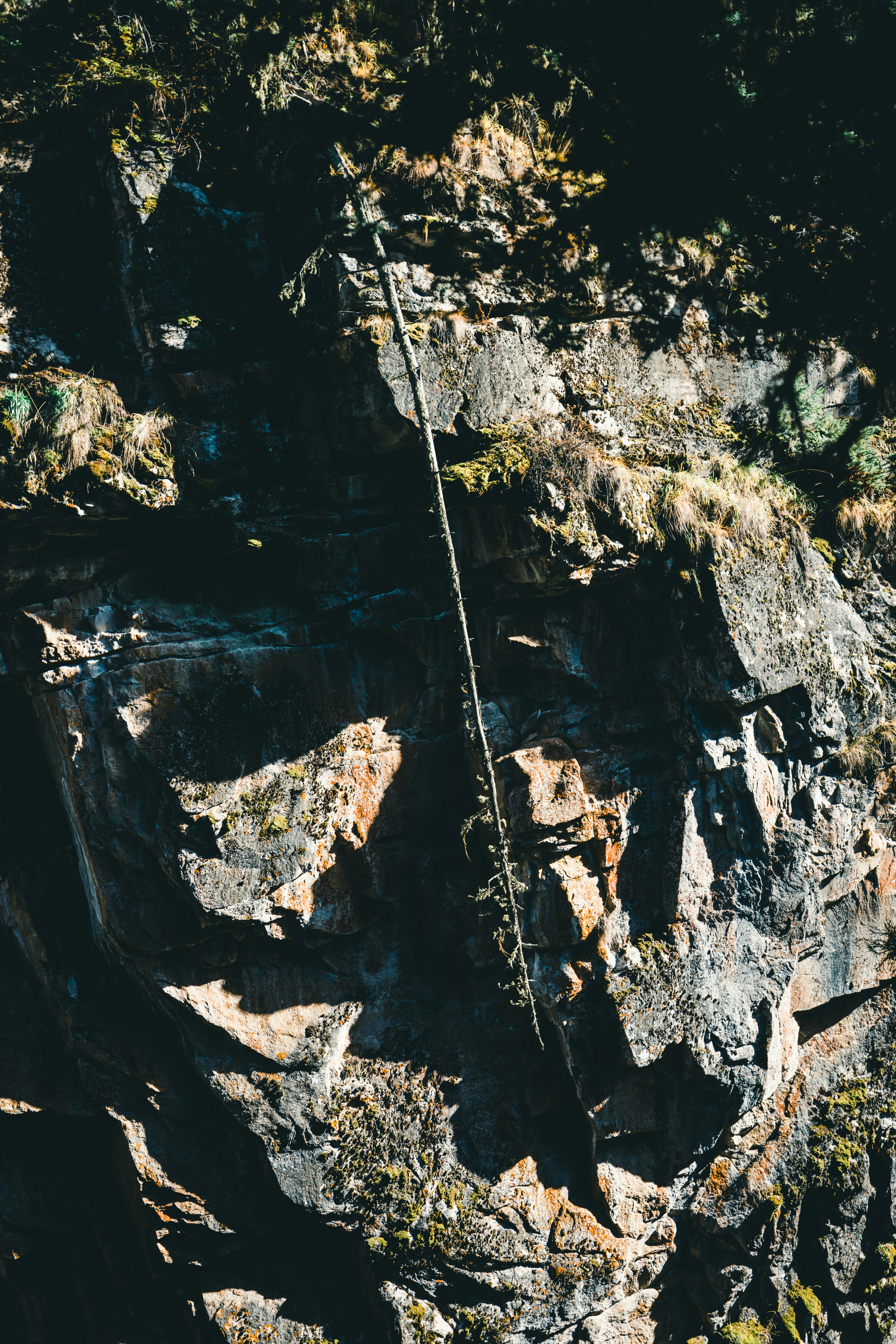 A man climbing up the side of a mountain