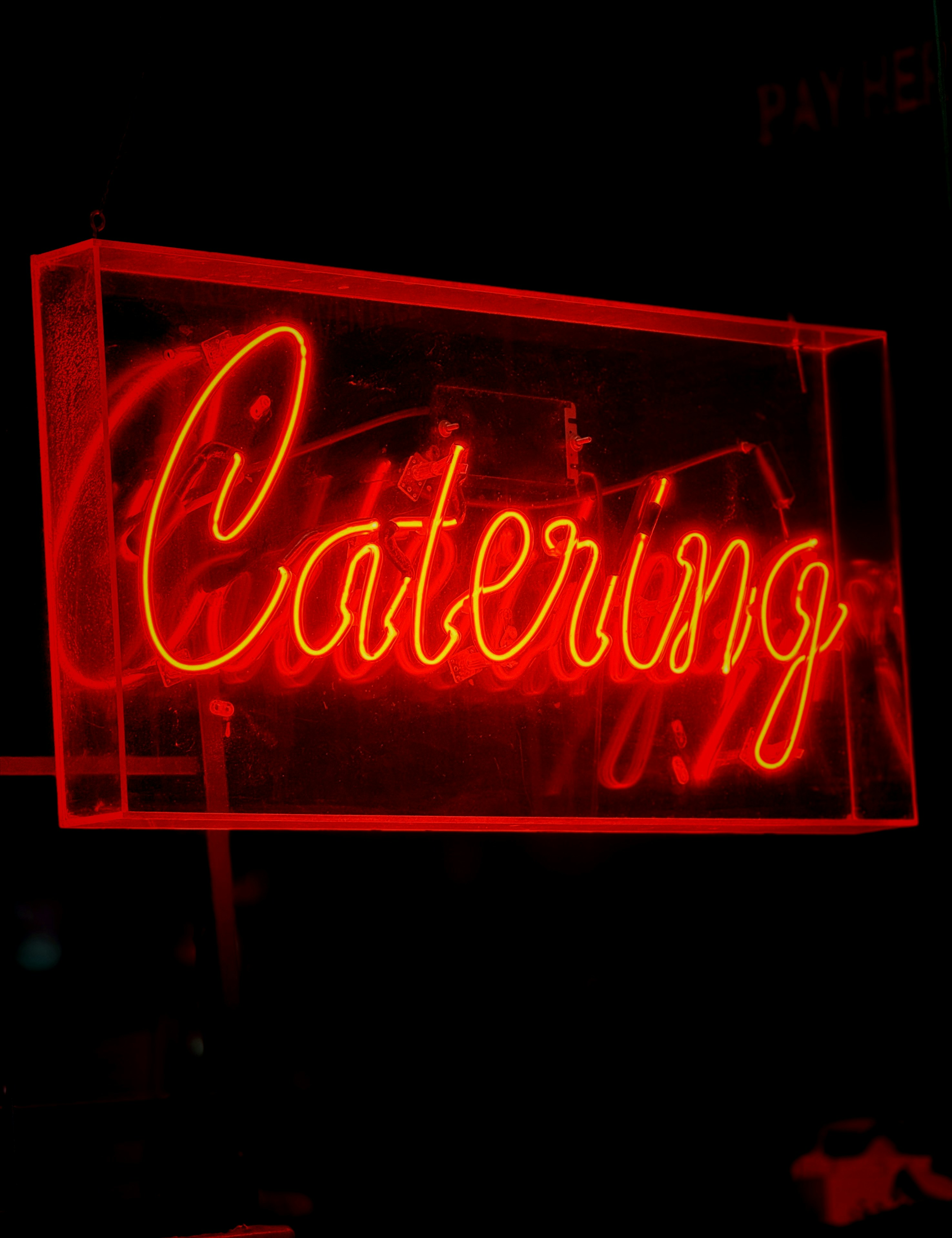 A neon sign that says catering on it