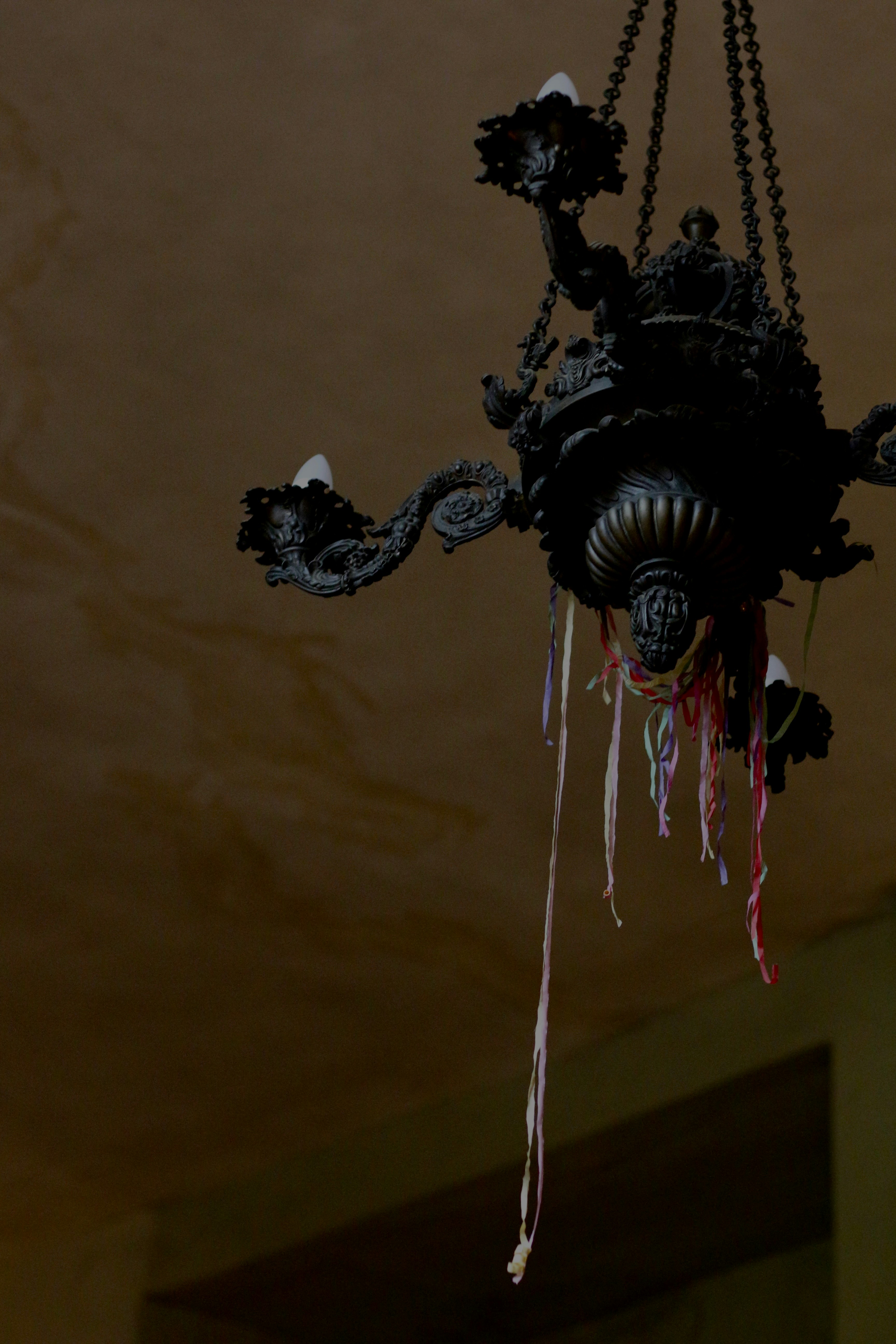 A chandelier hanging from a ceiling in a room