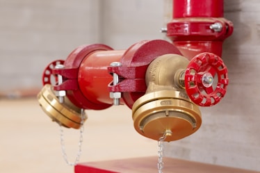 A close up of a red and gold fire hydrant