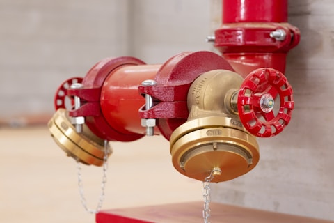 A close up of a red and gold fire hydrant
