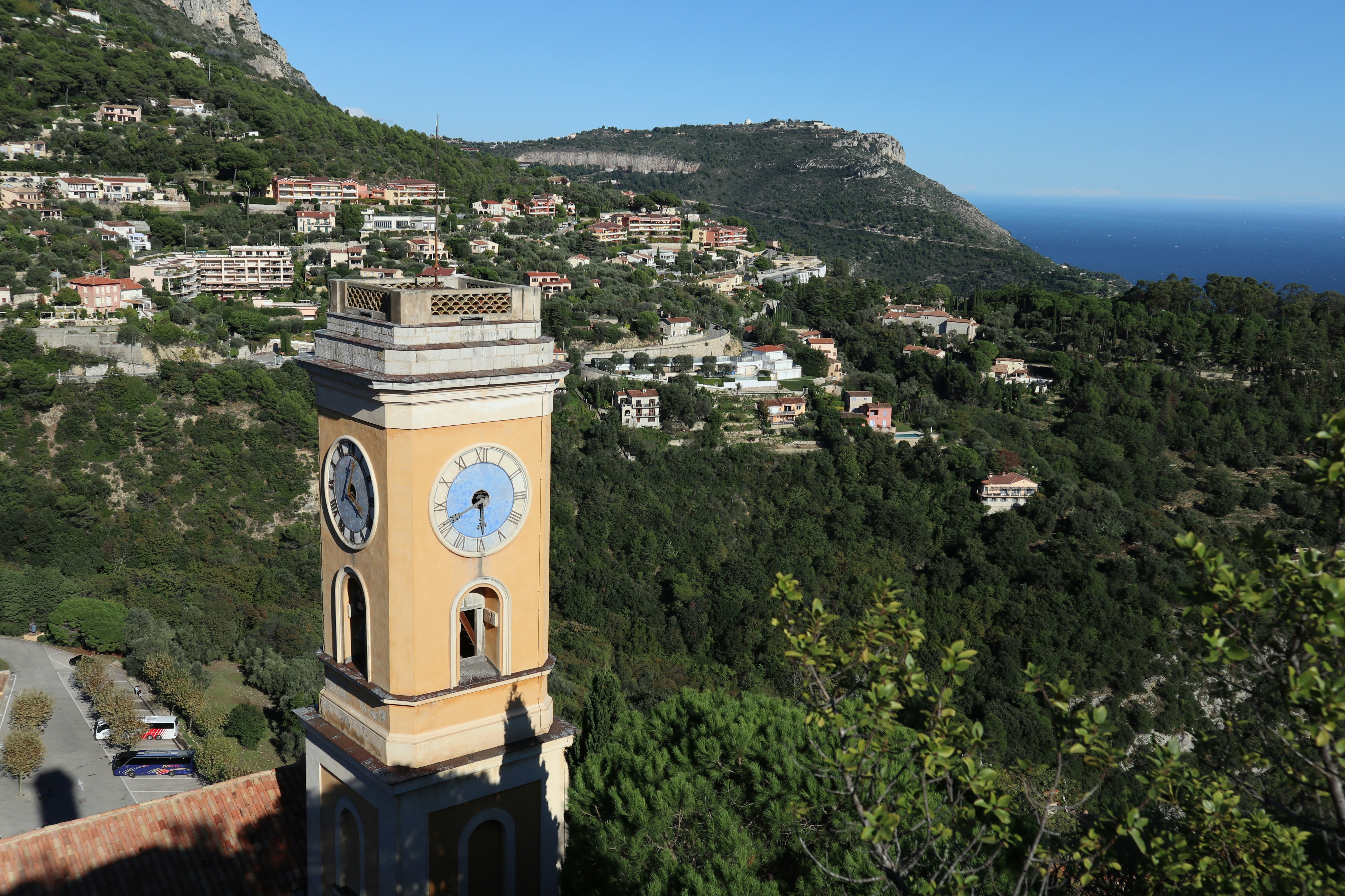 A clock tower on top of a building with a mountain in the background