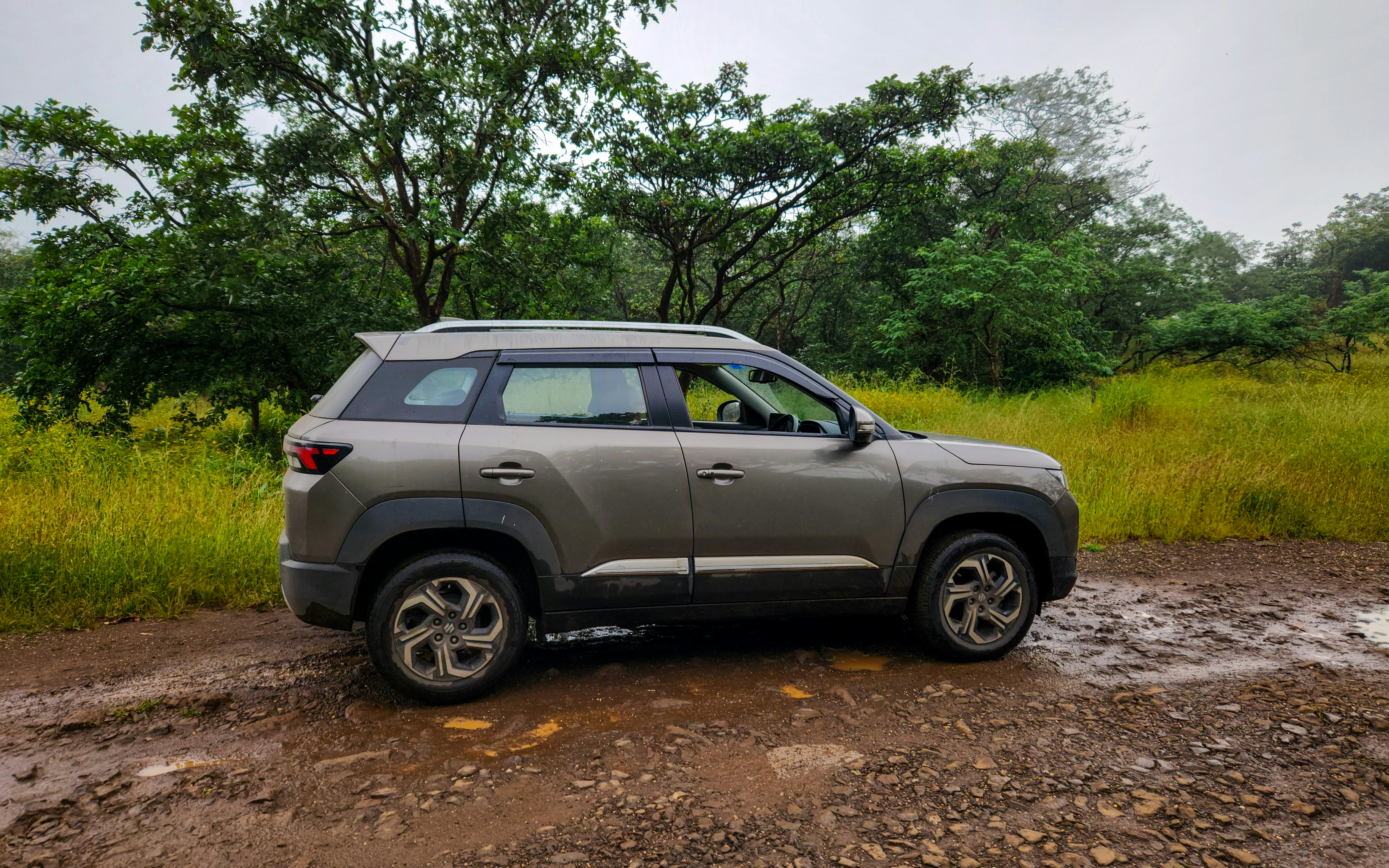 A car is parked on a muddy road