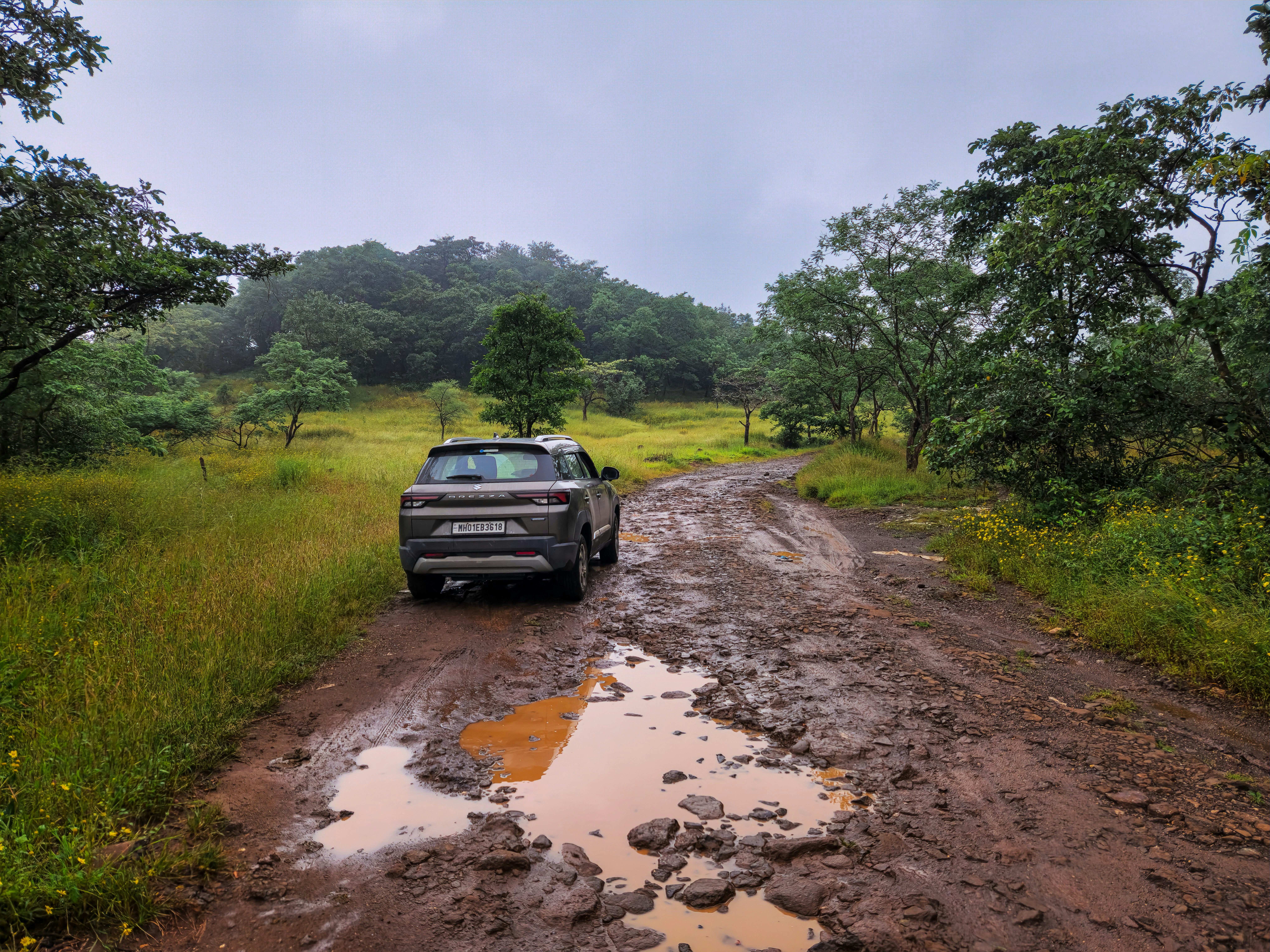 A car is parked on a muddy road
