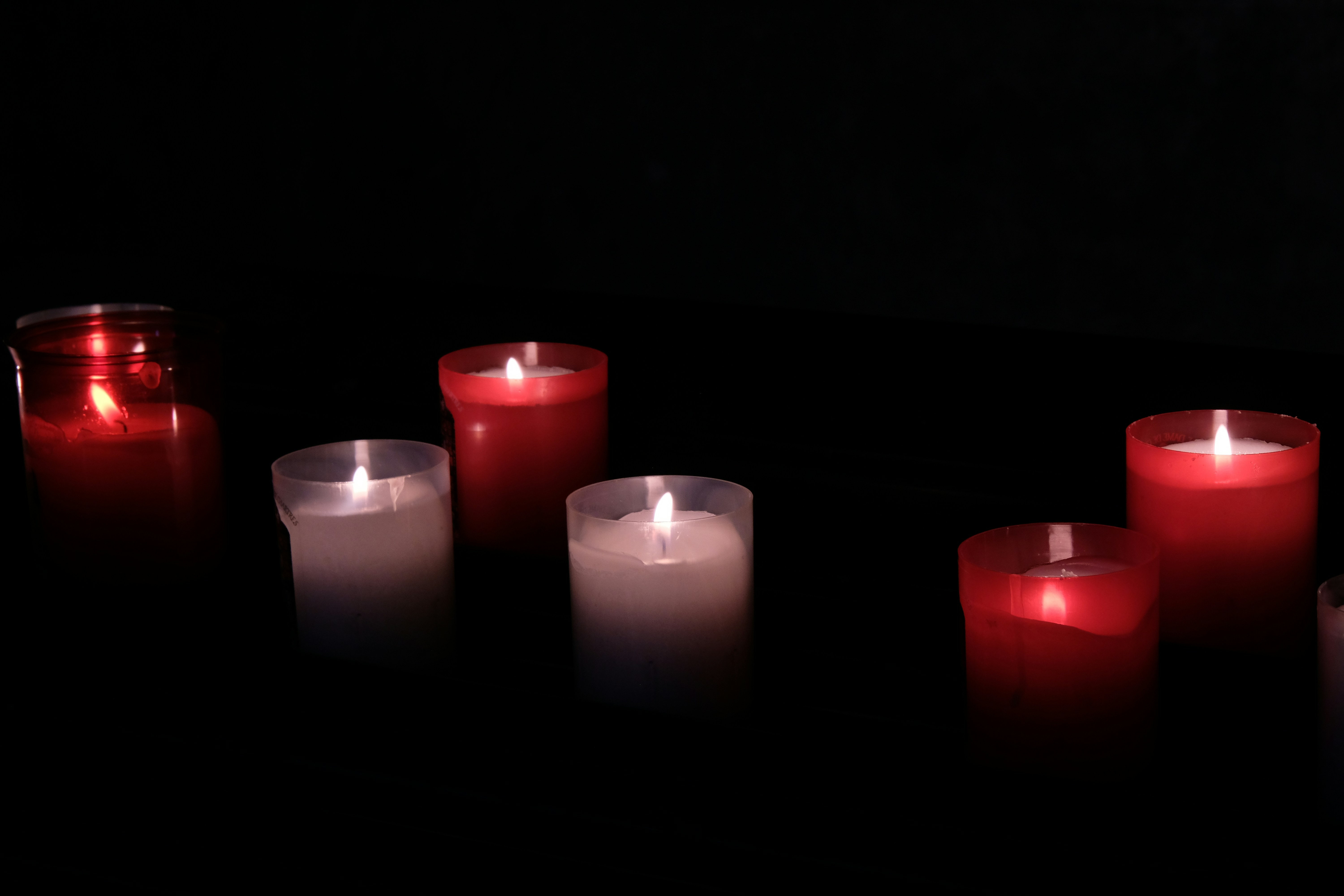 A group of lit candles sitting on top of a table