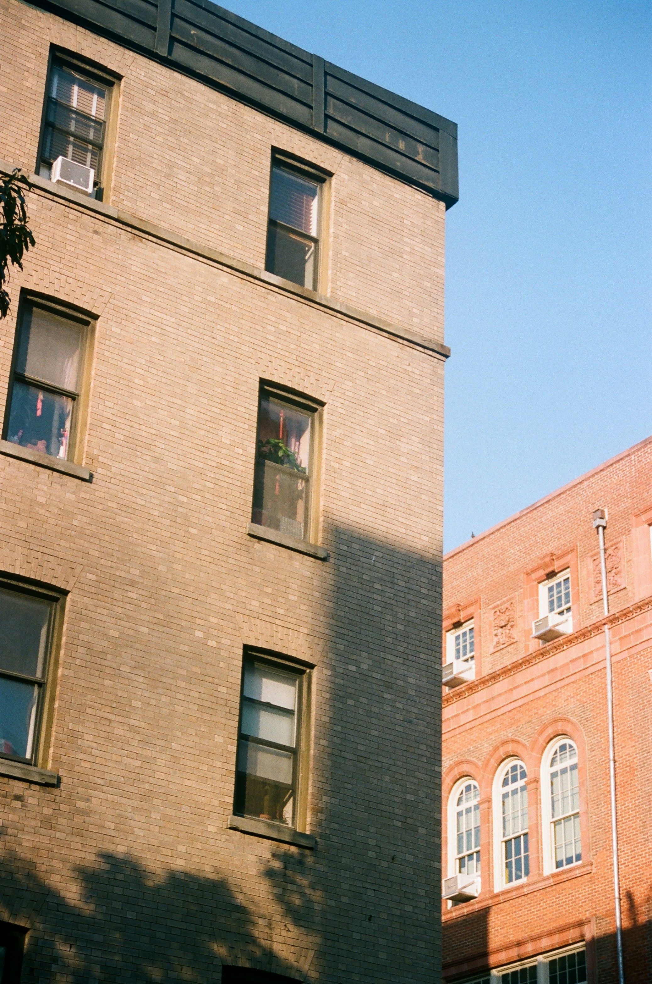 A tall brick building sitting next to a tall brick building