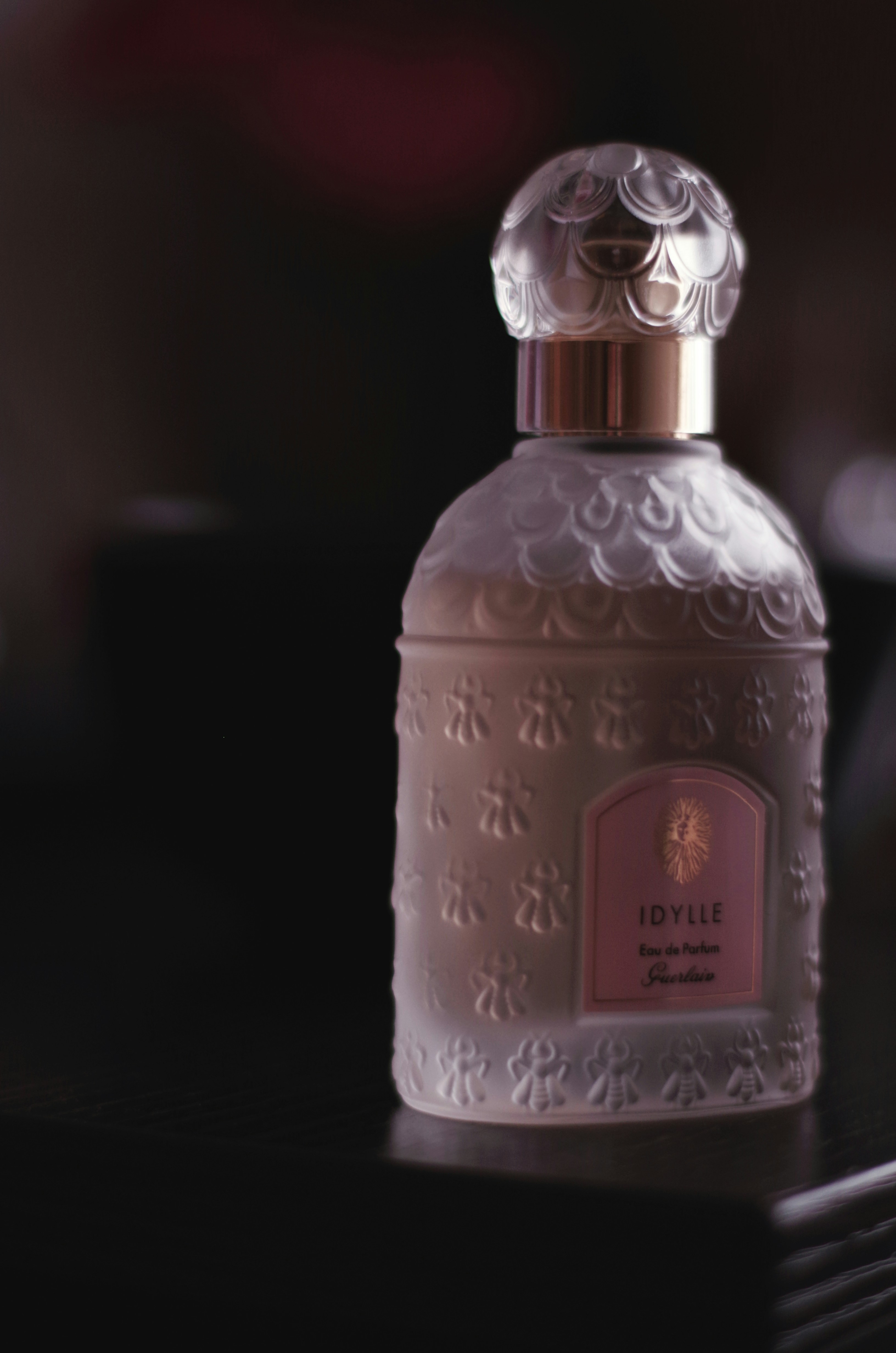 A bottle of perfume sitting on top of a table