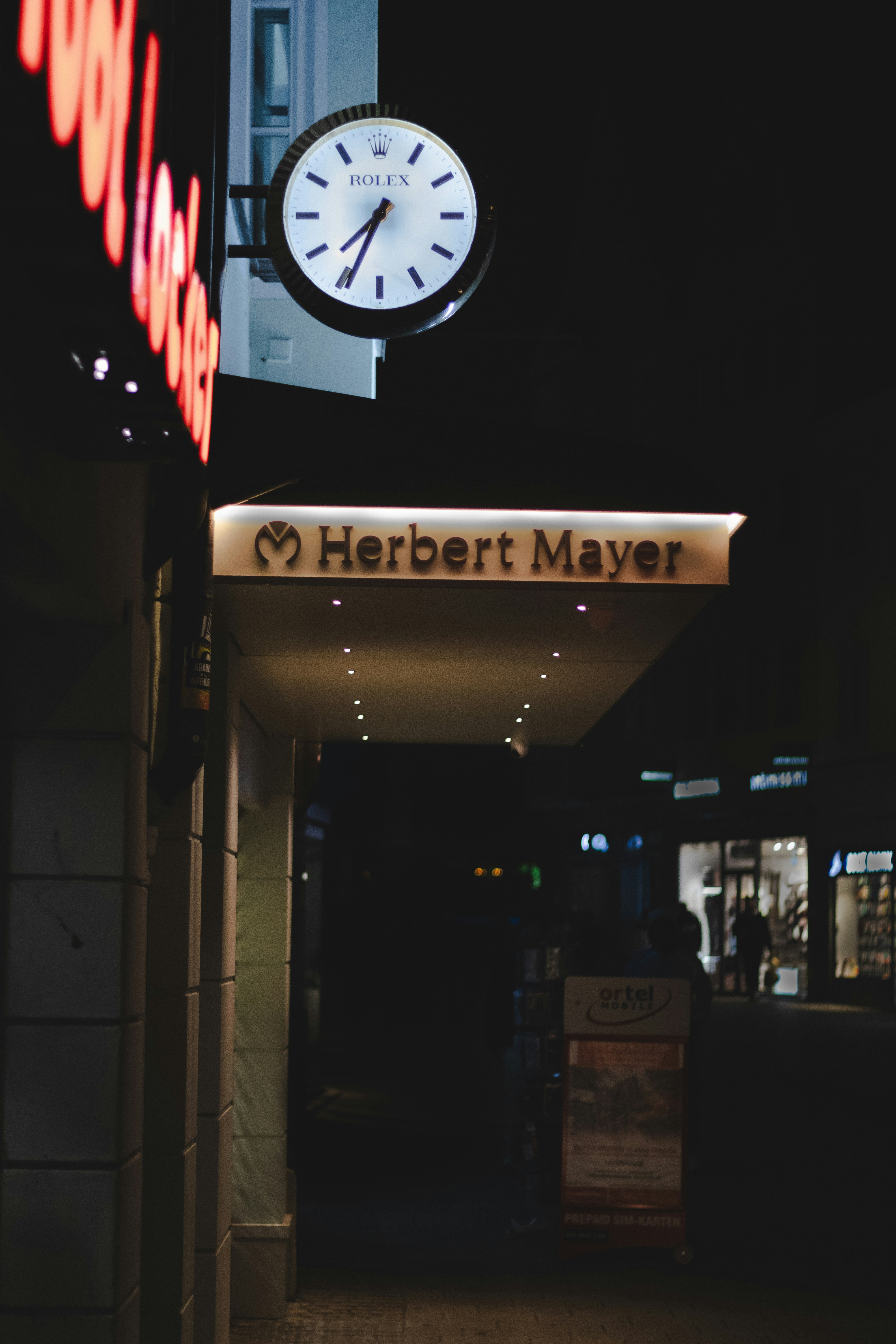 A clock on the side of a building at night