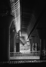 A black and white photo of a subway station