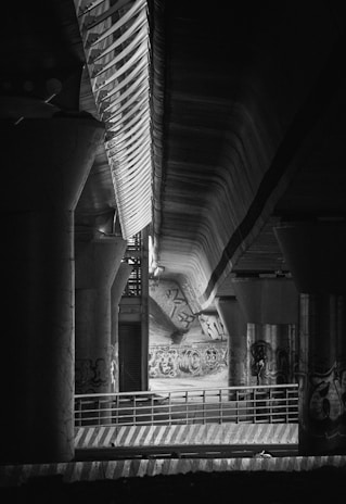 A black and white photo of a subway station