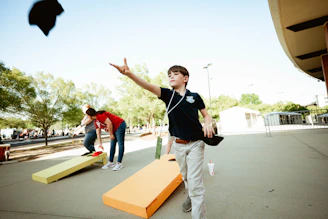 A young man is throwing a graduation cap in the air