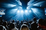 A large crowd of people in a dark room