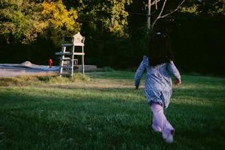 A person running in a field with a frisbee