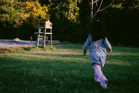 A person running in a field with a frisbee