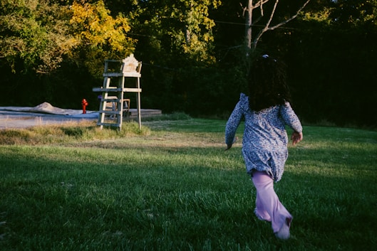 A person running in a field with a frisbee