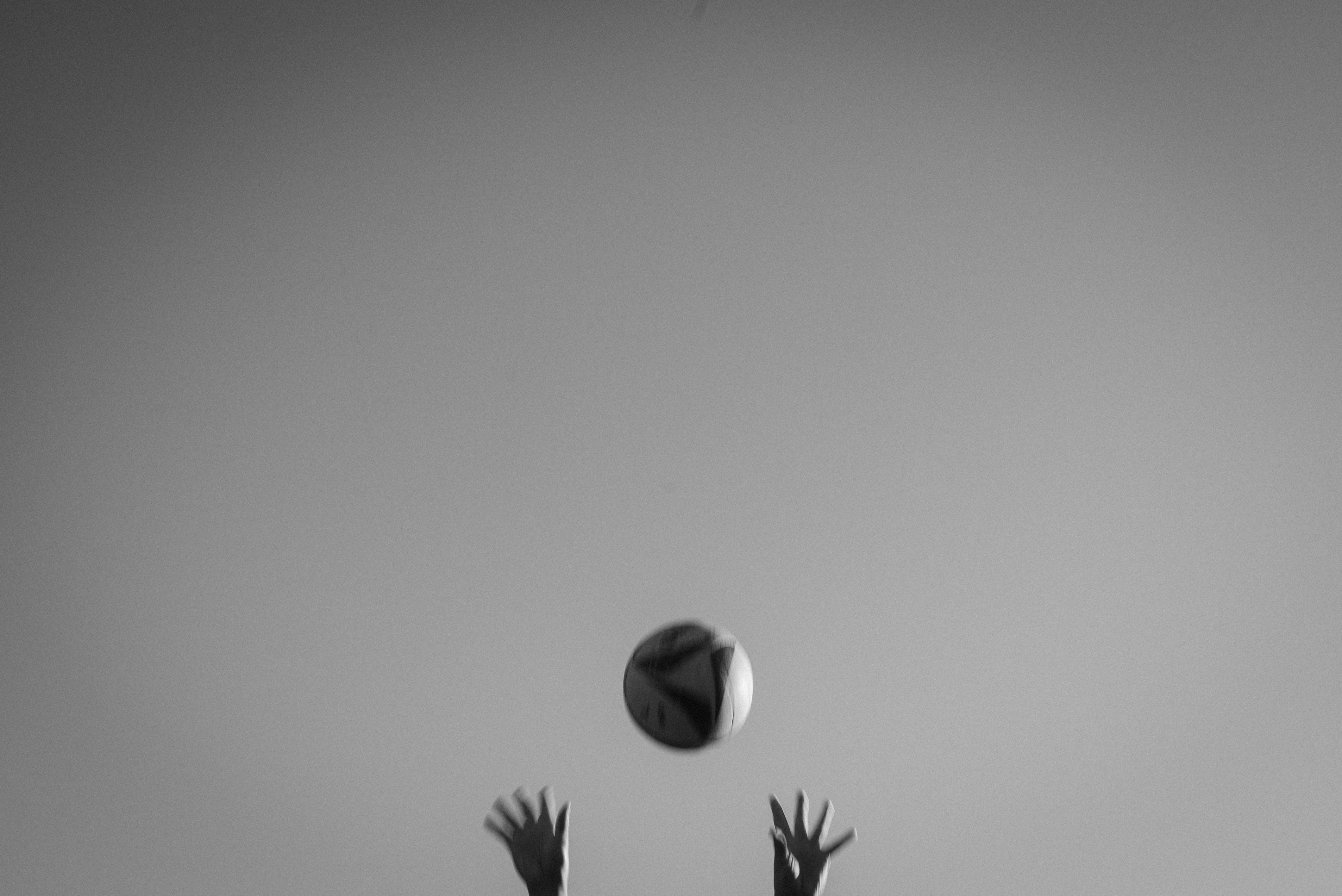 A person reaching up to catch a ball