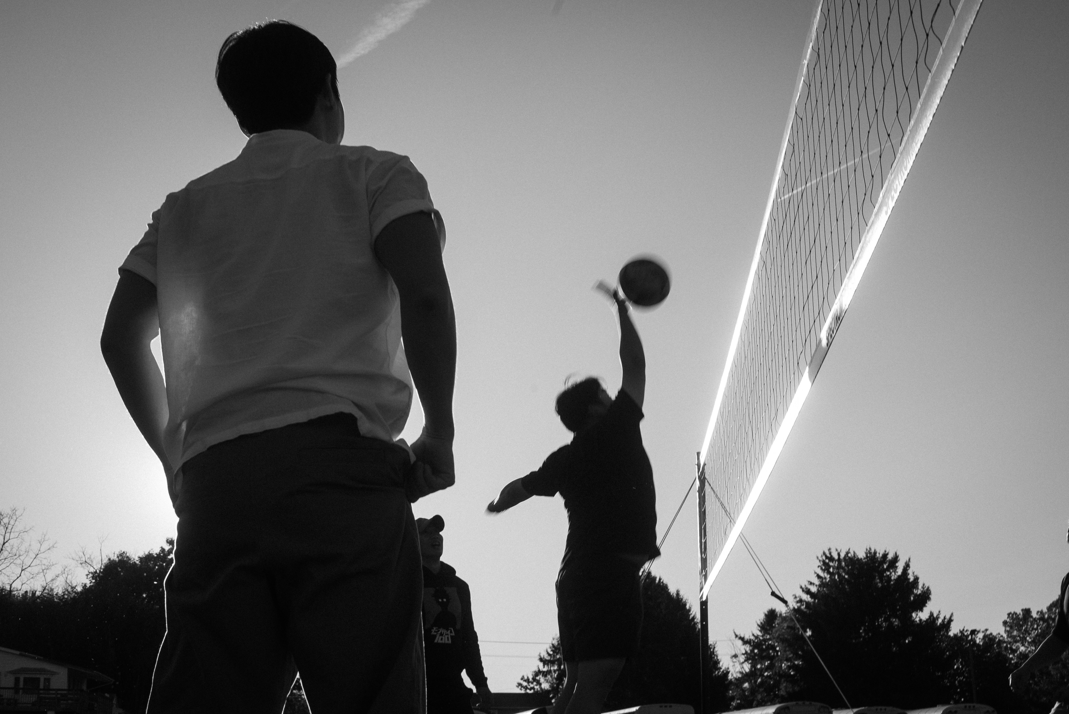 A couple of men standing on top of a tennis court