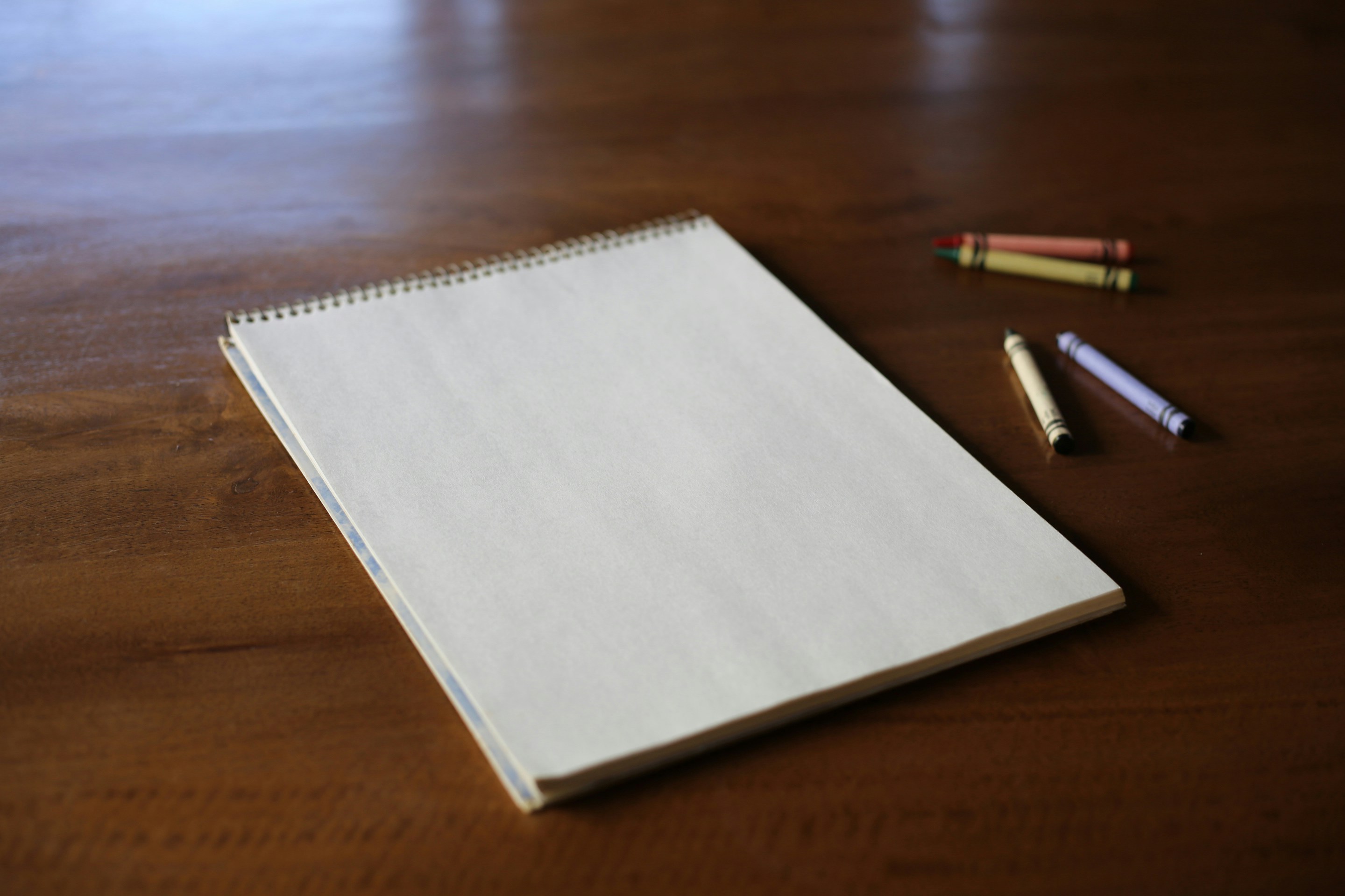 A blank white sheet of paper on a brown table.