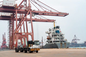 A large crane sitting next to a large ship