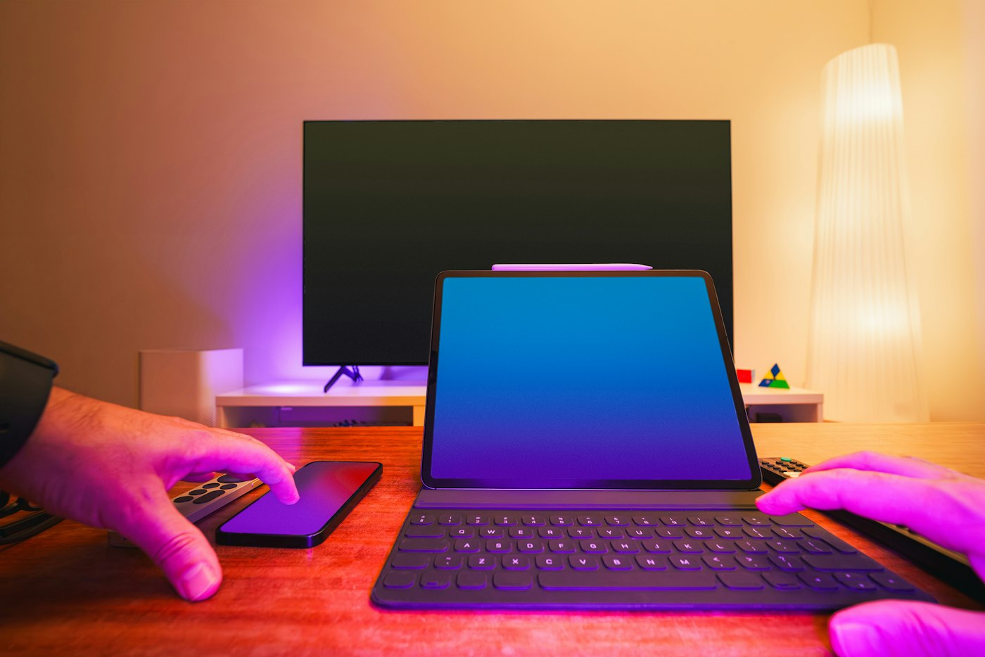 Hands on a tablet keyboard at a home desk