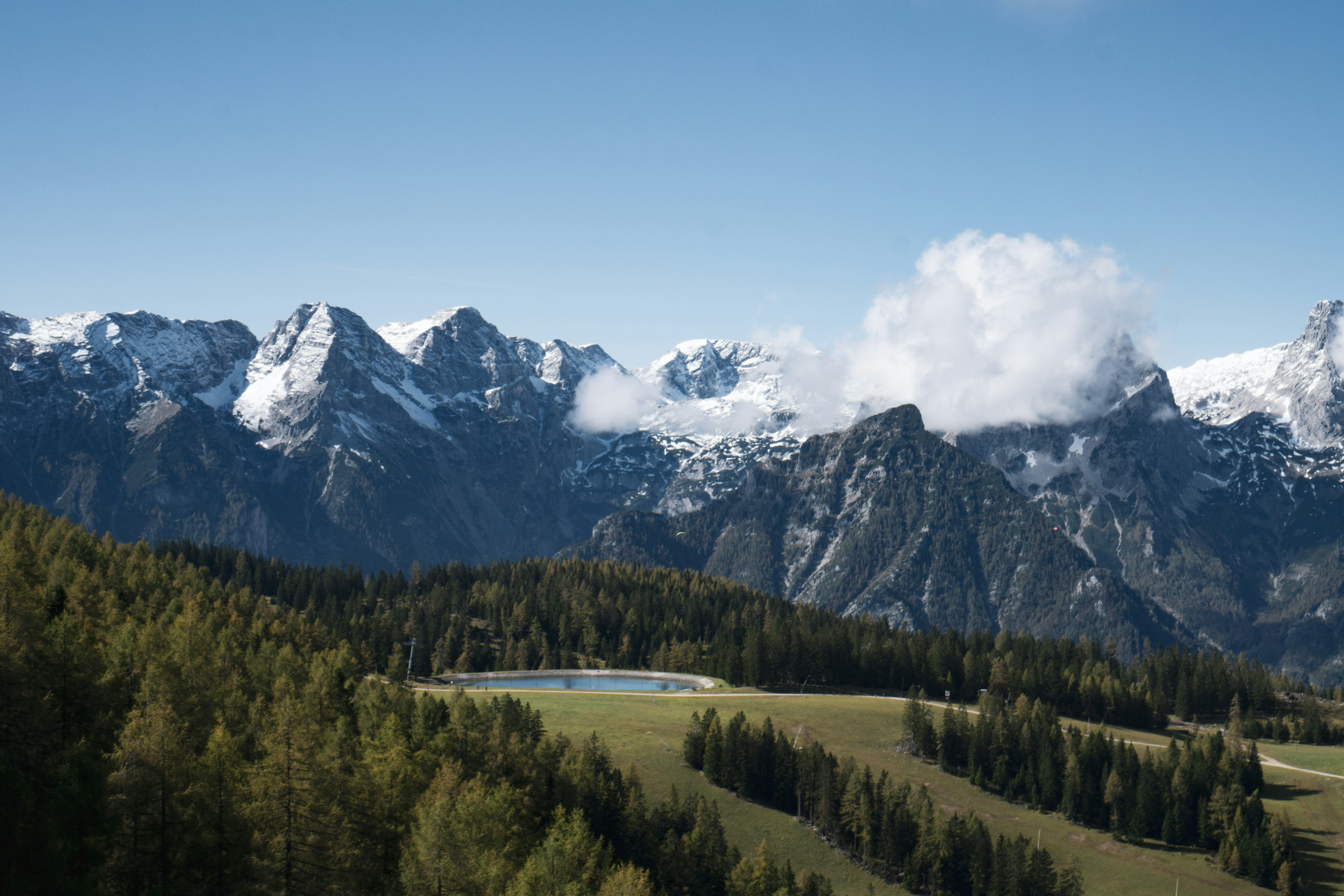 A scenic view of a mountain range with a lake in the foreground