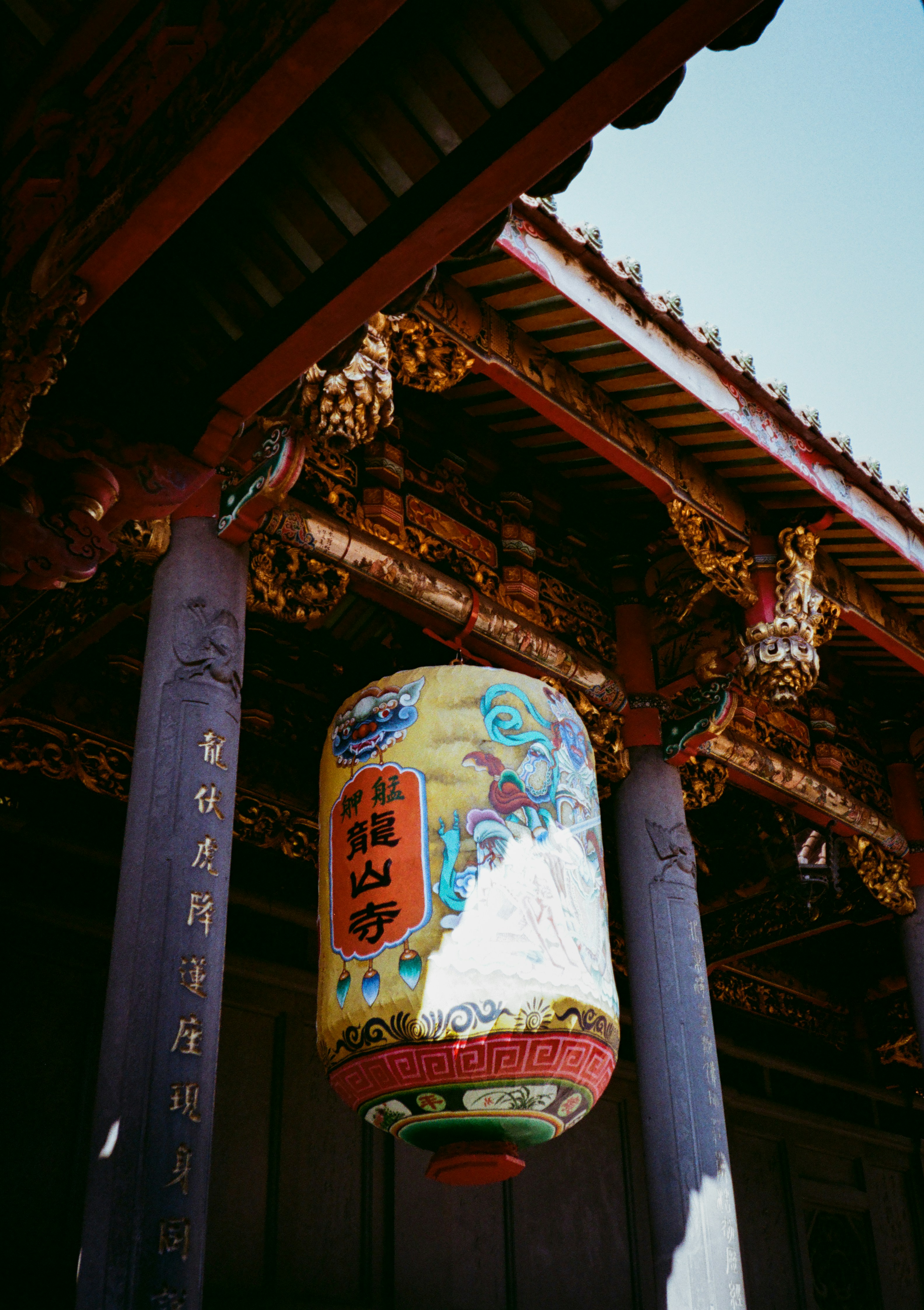 A chinese lantern hanging from the side of a building
