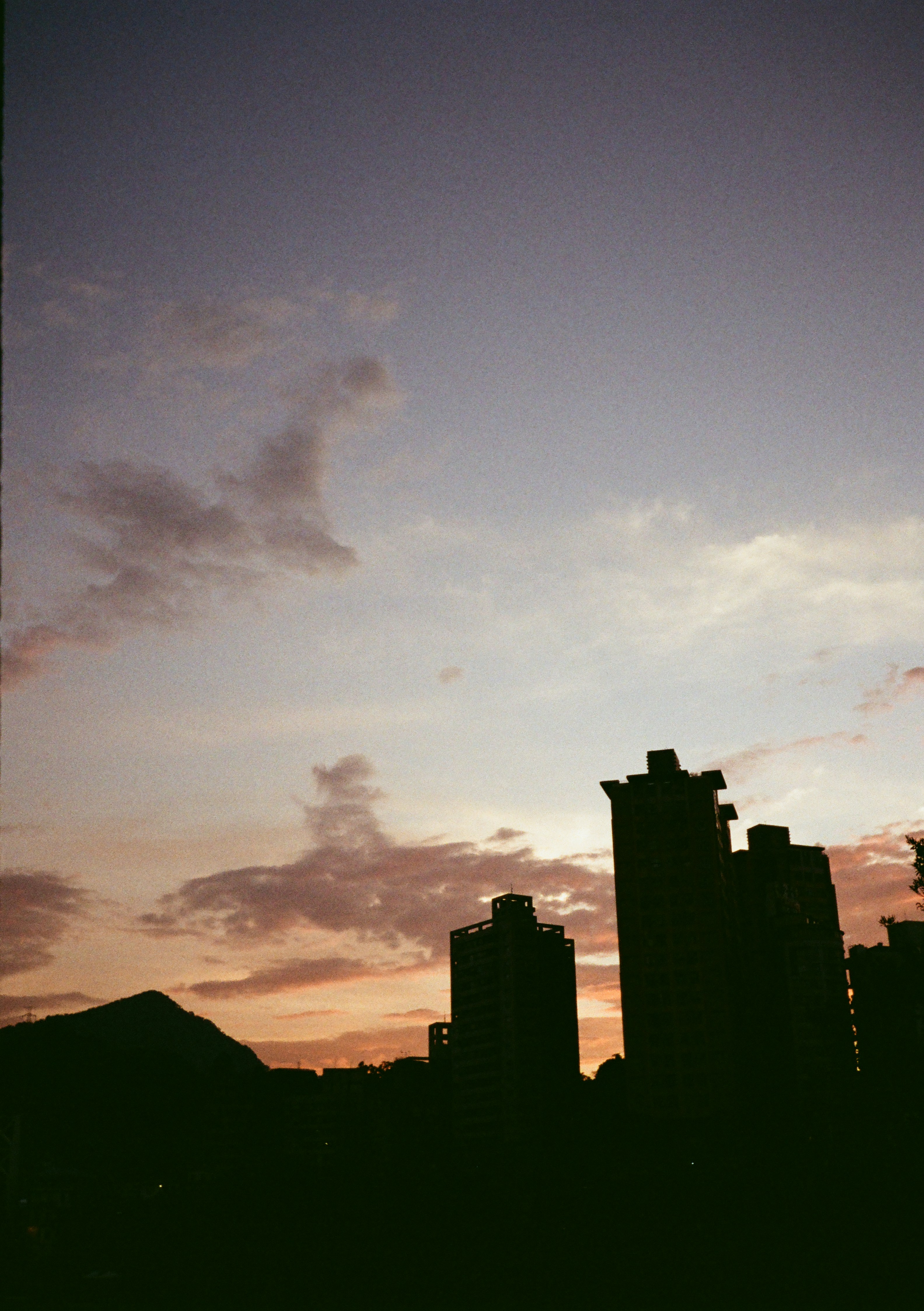 A view of a city skyline at sunset