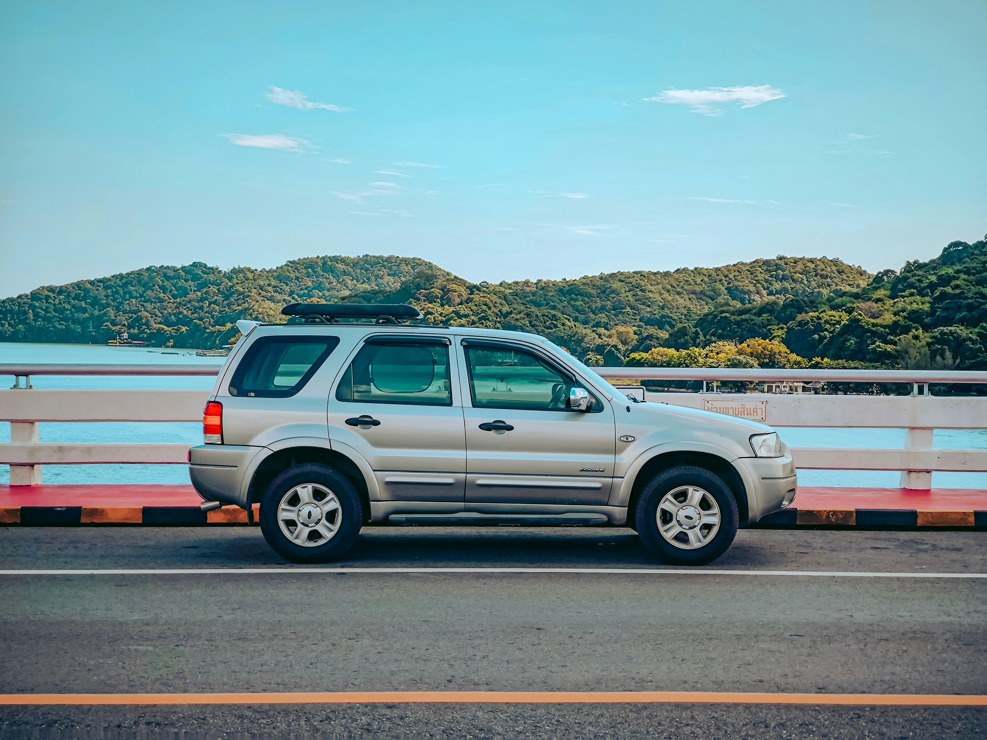 A silver suv parked on the side of the road
