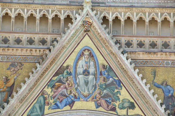 A close up of a building with a painting on the side of it — Orvieto, Italy