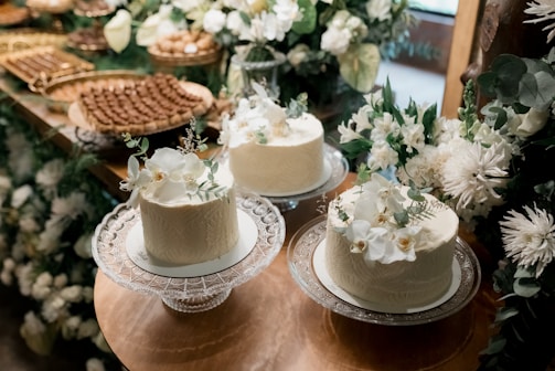 A table topped with three cakes covered in frosting
