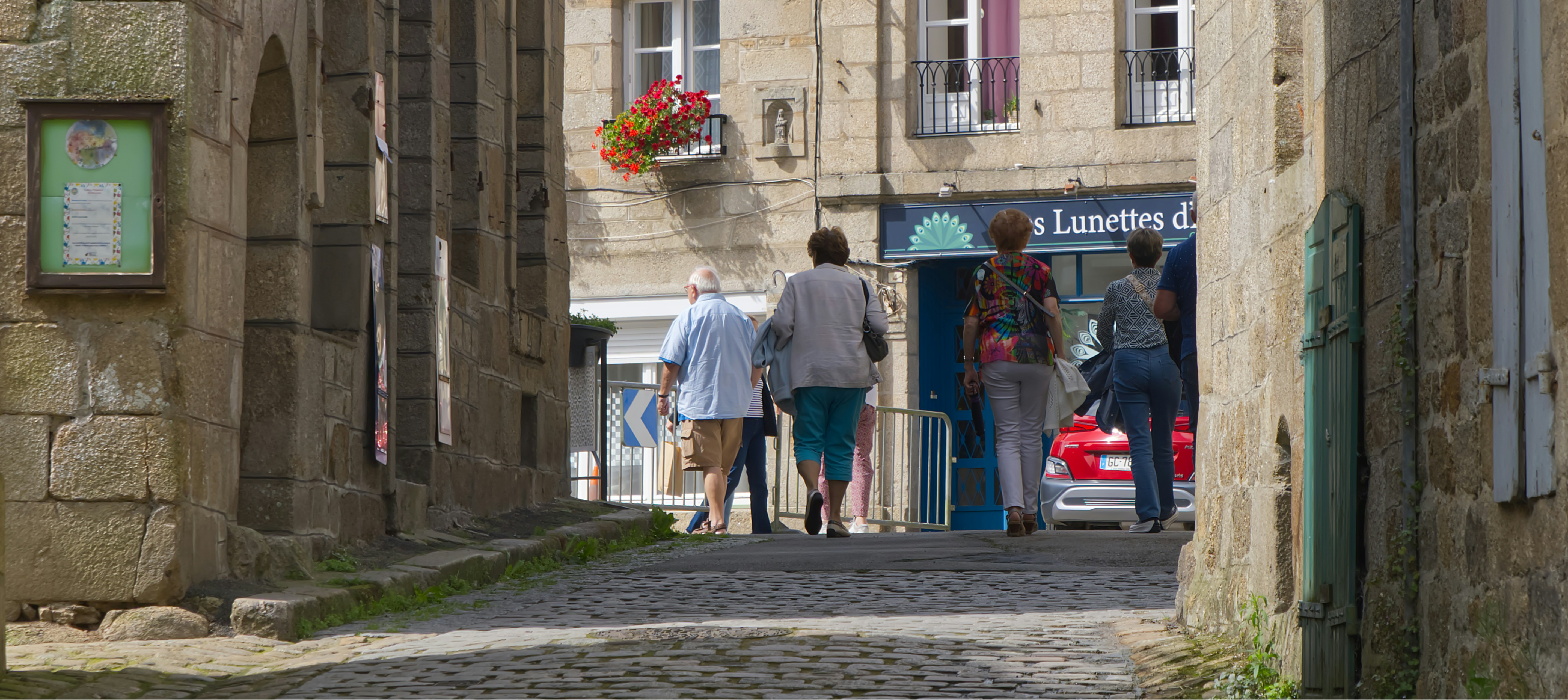 A couple of people that are walking down a street