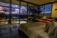 A bedroom with a large bed sitting next to a window