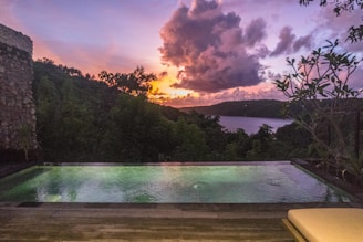 A swimming pool with a view of a lake