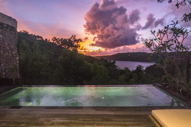 A swimming pool with a view of a lake